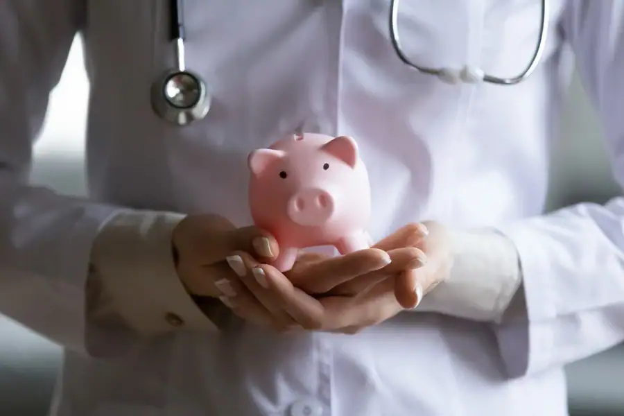 Therapist Holding Piggy Bank Suffolk County New York in Suffolk, New York