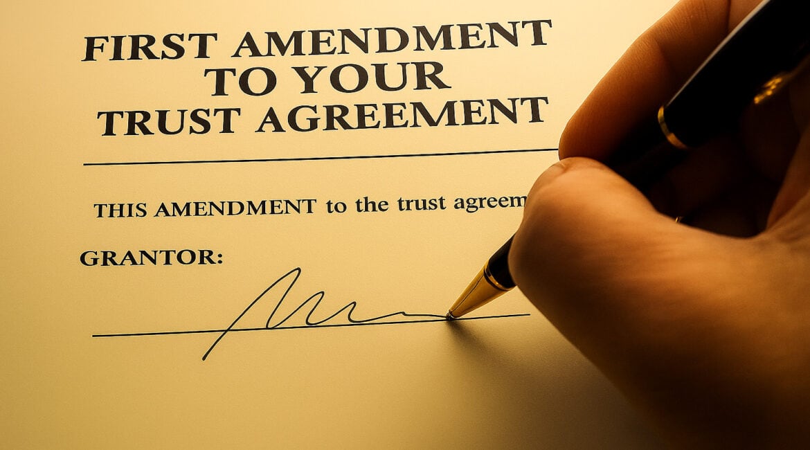 A hand holding a pen signs a document titled "First Amendment to Your Trust Agreement," ready for the grantor’s signature. Warm lighting highlights this moment, perfect for Elder Law guidance in Smithtown, NY.
